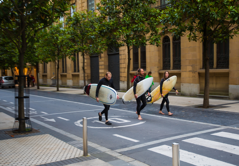 Surfers walk through the city towards La Concha beach, San Sebastián. Photo: Getty Images