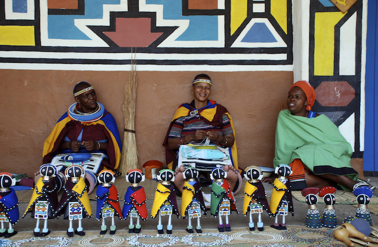 Ndebele women sell traditional dolls in Lesedi African Lodge and Cultural village, South Africa. Credit: iStock.com.