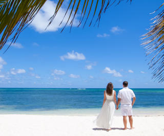 Wedding couple on beautiful white sand beach (Shuttterstock) 